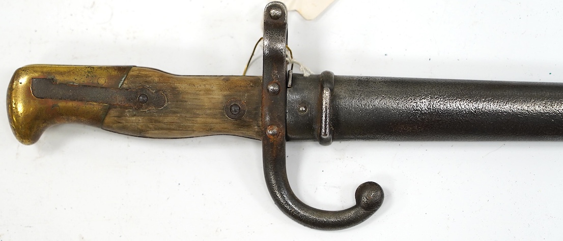 An 1880 French bayonet and scabbard for a Gras rifle. Condition - good, some pitting